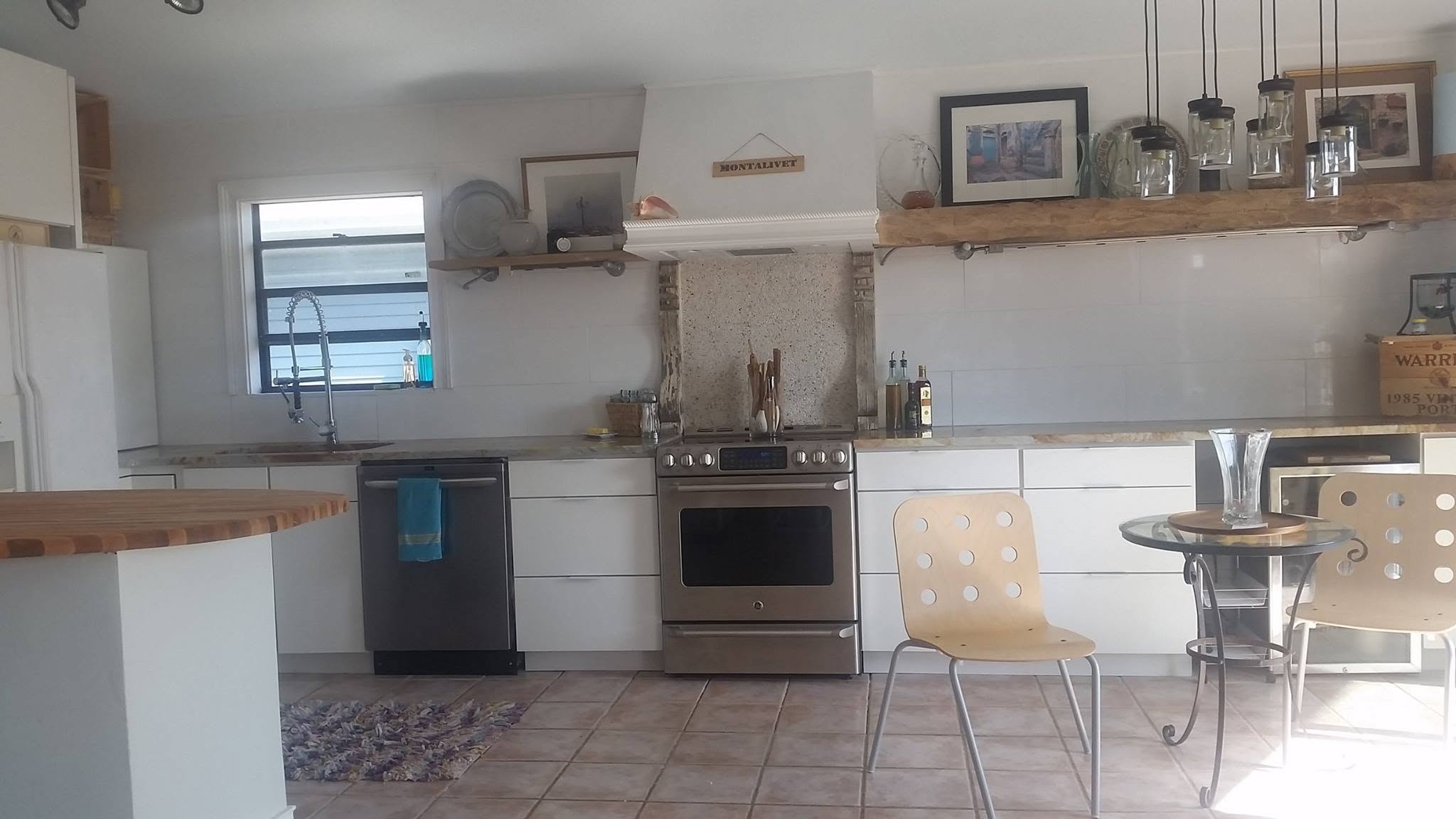 Finished kitchen with white cabinets, tiled floor, and stainless steel appliances